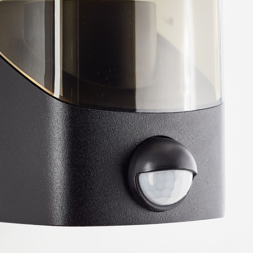 Brilliant - Utomhus vägglampa med sensor MINOU 1xE27/10W/230V IP44 svart/rökig